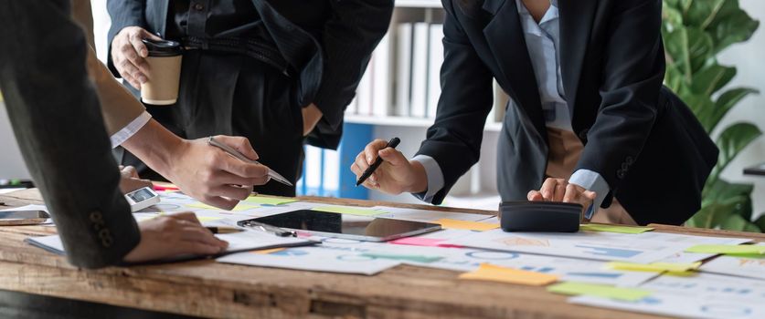 Business people analyzing investment graph meeting brainstorming and discussing plan in meeting room, investment concept.