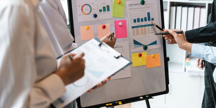 Asian business colleagues meeting to analyze financial reporting situation Investment and accounting concept sitting table and pointing at document. Profit chart. Graph showing growth.