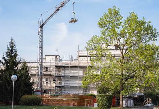 Construction and decoration of scaffolds of the building. Tower crane.