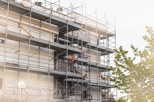 Construction and decoration of scaffolds of the building.Construction concept. Scaffolding and remodeling old building