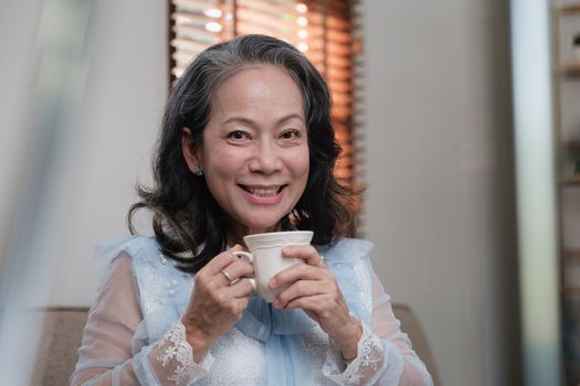 Senior woman good healthy drinking tea or coffee at home. Exercise and healthy diet concept.