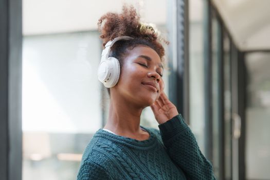 Young Black Woman Listening To Music Online Wearing Wireless Earphones, Enjoying Favorite Song. Playlist, Music Application.