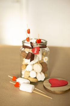 sweet gift for Valentine's Day with your own hands. A gift for the holiday made of heart-shaped candies and marshmallows.