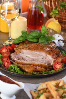 Sliced baked turkey drumstick on a vegetable tray at the Thanksgiving dinner table