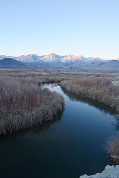 river bend with mountain peaks of sierra nevada mountain range near big pine california