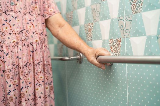 Asian senior or elderly old lady woman patient use toilet bathroom handle security in nursing hospital ward, healthy strong medical concept.