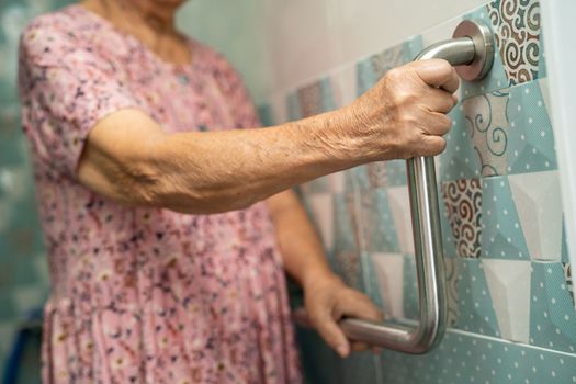 Asian senior or elderly old lady woman patient use toilet bathroom handle security in nursing hospital ward, healthy strong medical concept.