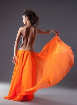 beauty woman dance in orange veil with naked spine - arabia style