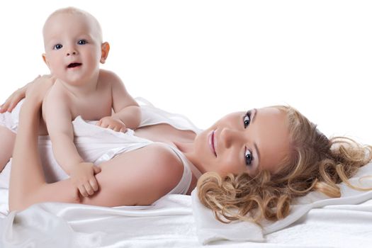 Portrait of mother and baby in bed. Isolated on white