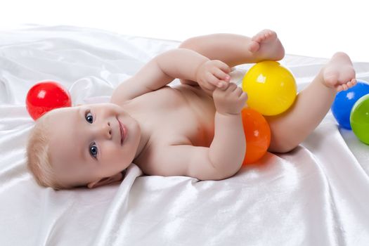 Portrait of happy baby with colored balls. Isolated on white