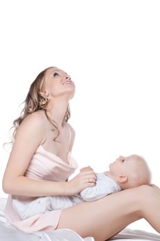 Mother with baby in bed. Isolated on white