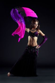 Full length portrait of sexy oriental dancer with shawl