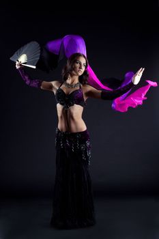 Full length portrait of pretty oriental dancer with shawl