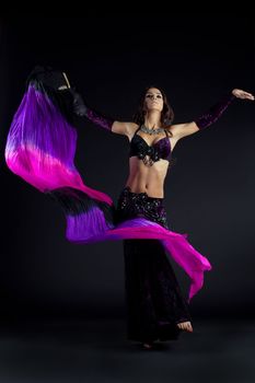 Full length portrait of beautiful oriental dancer with shawl