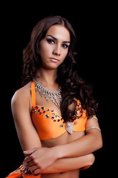 Studio portrait of oriental dancer in orange costume