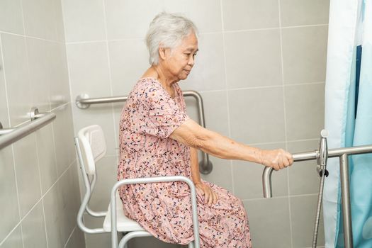 Asian senior or elderly old lady woman patient use toilet bathroom handle security in nursing hospital ward, healthy strong medical concept.