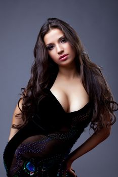 Glamour portrait of oriental dancer with long hair in black dress