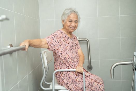 Asian senior or elderly old lady woman patient use toilet bathroom handle security in nursing hospital ward, healthy strong medical concept.