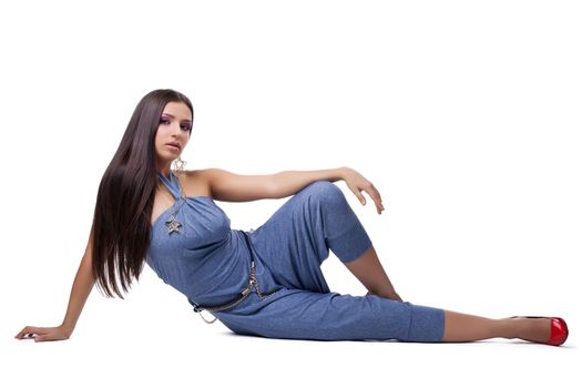 Full length portrait of brunette young woman in overalls. Isolated on white
