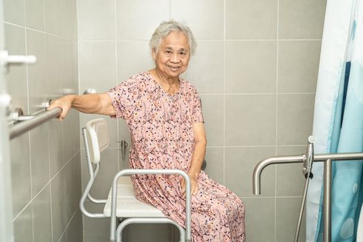 Asian senior or elderly old lady woman patient use toilet bathroom handle security in nursing hospital ward, healthy strong medical concept.