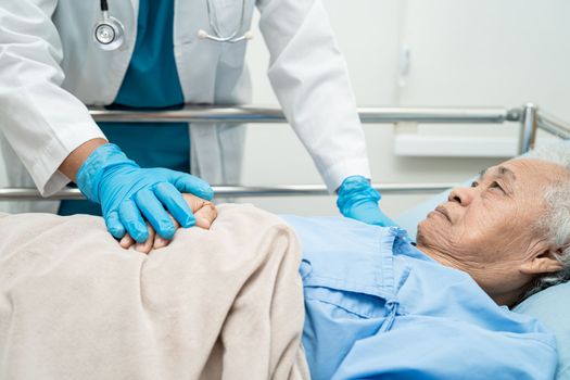 Doctor touching hands Asian senior or elderly old lady woman patient with love, care, encourage and empathy at hospital.