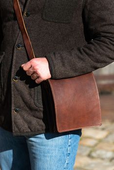 close-up photo of brown leather bag . outdoors photo