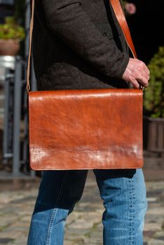 close-up photo of light brown leather bag . outdoors photo