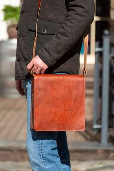close-up photo of light brown leather bag . outdoors photo
