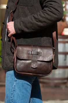 close-up photo of brown leather bag . outdoors photo