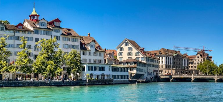 Picturesque view of the promenade and houses at the Schipfe on the Limmat riverbank in Zurich, Switzerland