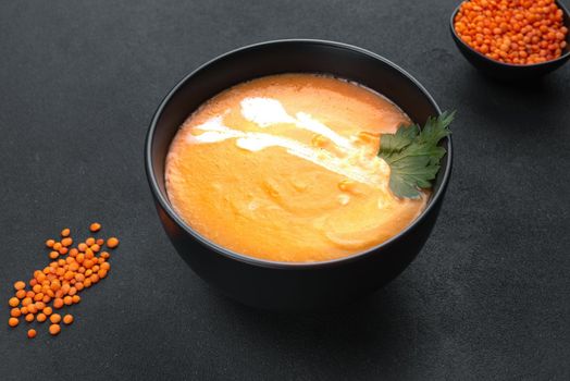 Red lentil soup on a dark background top view. Traditional Middle Eastern, Turkish, Ramadan cuisine. Vegan Cuisine.