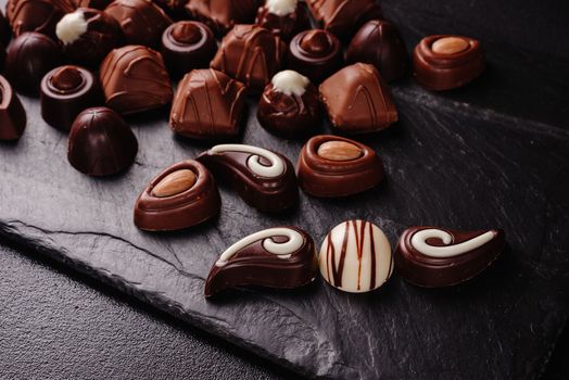 chocolate candies with various fillings, sweet food background. mix and match set of different candies. chocolates with different fillings, sweet food background. Copy space