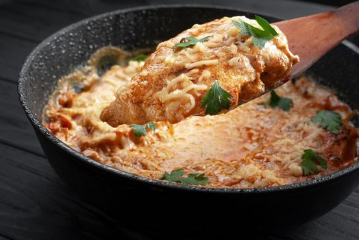 Chicken tikka masala. Black background. Place for text. Chicken in oil, a traditional Indian dish. Top view. Chicken tikka masala. Indian Cuisine.