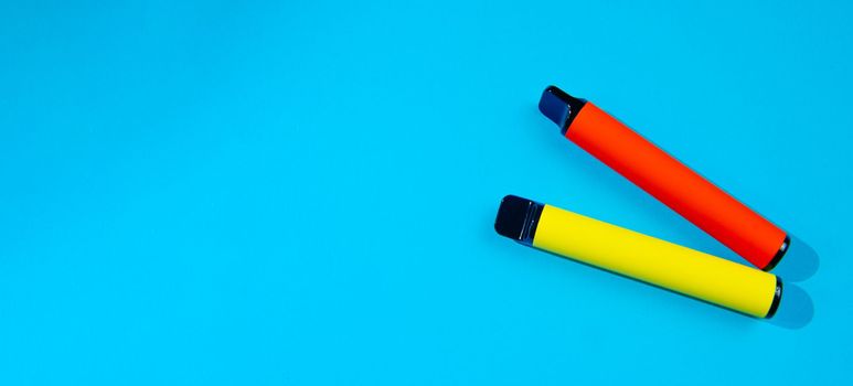 Electronic cigarettes in blue background color with blank space for text. An alternative to smoking. Modern cigarettes.