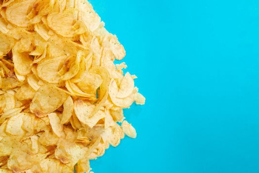 Fried foods are bad for your health. Healthy Eating. Chips, fried potatoes. Unhealthy foods. Blank space for text. Harmful food. Fried potatoes and chips on a blue background. Fried food is bad for your health