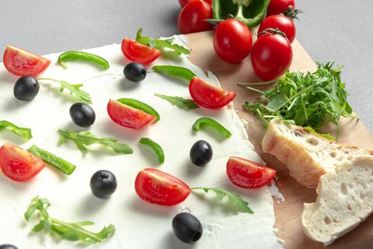 A board of butter or cream cheese on a wooden board. Appetizer. Top view. Butter board food trend, cracker with butter.