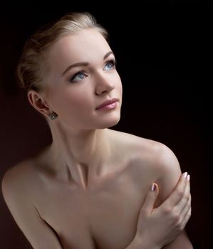 Amazing naked woman studio portrait hide breast with hands