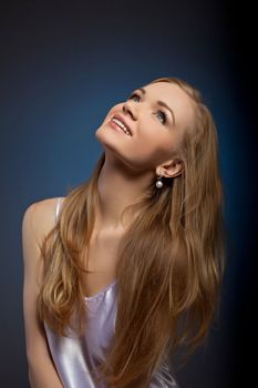Young sexy woman studio portrait look at light smile