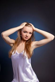 Amazing woman studio portrait in white on blue