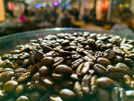 Big container full of coffee beans lighten by shining sun