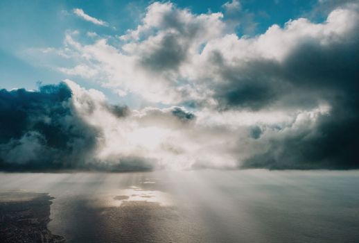 Blue sky with white clouds over calm summer panorama of the sea. Drone aerial view. Abstract aerial nature summer ocean sunset sea and sky background. Horizon. No people. Holiday and vacation concept