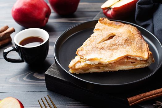 Autumn food. Homemade apple pie with slice with fresh red apples on wooden table