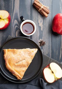 Autumn food. Homemade apple pie with slice with fresh red apples on wooden table