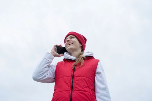 Woman wearing sport clothes and knee brace or orthosis after leg surgery, walking down the stairs in the park. Medical and healthcare concept.