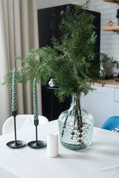 Merry Christmas and Happy New Year. Christmas tree with presents and lights in light and airy living room next to the window