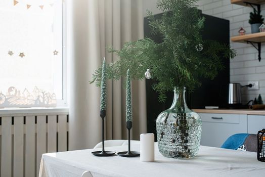 Merry Christmas and Happy New Year. Christmas tree with presents and lights in light and airy living room next to the window