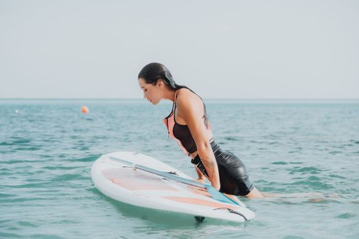 Sea woman sup. Silhouette of happy young woman in pink bikini, surfing on SUP board, confident paddling through water surface. Idyllic sunset. Active lifestyle at sea or river. Slow motion