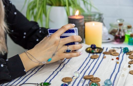A fortune teller reads with tarot cards. Selective focus. Woman.