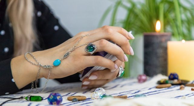 A fortune teller reads with tarot cards. Selective focus. Woman.