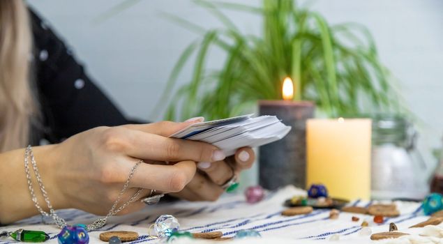 A fortune teller reads with tarot cards. Selective focus. Woman.